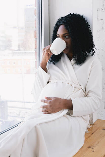 Woman drinking tea during early labor Doula in Utah county